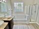 Bathroom with double vanity sinks, bathtub and shower, offering comfort and style at 10305 Lakeland Dr, Fishers, IN 46037