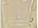 Clean bathroom featuring a tub and shower combination with white tile and updated fixtures at 10305 Lakeland Dr, Fishers, IN 46037