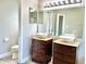 The bathroom features double vanity sinks and a toilet for convenience at 10305 Lakeland Dr, Fishers, IN 46037
