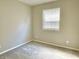This bedroom has neutral walls, gray carpet, a window with blinds, and electric wall outlets at 10305 Lakeland Dr, Fishers, IN 46037