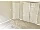 Bedroom with neutral walls, gray carpet, a closet with sliding doors, and an access door at 10305 Lakeland Dr, Fishers, IN 46037