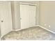 This bedroom has neutral walls, gray carpet, a sliding door closet, and two access doors at 10305 Lakeland Dr, Fishers, IN 46037