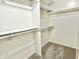 Organized walk-in closet with shelves and carpeted floor, offering ample storage space at 10305 Lakeland Dr, Fishers, IN 46037