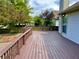 Wooden deck with wooden rails and view of treelined backyard at 10305 Lakeland Dr, Fishers, IN 46037