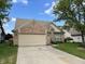 Charming brick home with a well-manicured lawn and a two-car garage at 10305 Lakeland Dr, Fishers, IN 46037
