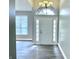Welcoming foyer with elegant light fixture and hardwood floors at 10305 Lakeland Dr, Fishers, IN 46037