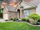 Beautiful single-story brick home with well-kept lawn, mature landscaping and neutral-colored trim at 10305 Lakeland Dr, Fishers, IN 46037
