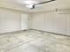 View of the large garage with access door and concrete floor, offering ample storage space at 10305 Lakeland Dr, Fishers, IN 46037