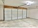 Spacious garage featuring a secure white garage door, concrete floor, and neutral walls at 10305 Lakeland Dr, Fishers, IN 46037