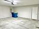 Spacious garage featuring concrete flooring, a utility door, and ample space for vehicles and storage at 10305 Lakeland Dr, Fishers, IN 46037