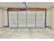 Spacious garage showcasing a white garage door, concrete floor, and storage-ready walls at 10305 Lakeland Dr, Fishers, IN 46037