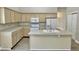 Spacious kitchen island with light wood cabinets and countertops provides ample storage and space for meal preparation at 10305 Lakeland Dr, Fishers, IN 46037