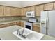 Open kitchen with light cabinets, modern appliances, and countertops for cooking, storage, and convenience at 10305 Lakeland Dr, Fishers, IN 46037