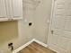 Functional laundry area with upper cabinets and utility connections, offering convenience and storage space at 10305 Lakeland Dr, Fishers, IN 46037