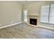 Inviting living room with a fireplace, glass doors, and hardwood flooring, creating a cozy and stylish atmosphere at 10305 Lakeland Dr, Fishers, IN 46037
