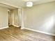 View of a room showcasing wood-look flooring, neutral walls, and access to hallway with closet space at 10305 Lakeland Dr, Fishers, IN 46037