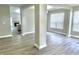 Bright living room with wood-look flooring, large windows, and an open floor plan provides ample natural light at 10305 Lakeland Dr, Fishers, IN 46037