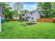 Extensive backyard with lush lawn, garden beds, and a view of the rear of the home and deck at 10310 Foxwood W Dr, Carmel, IN 46280