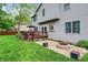Spacious backyard with a deck, patio, fire pit, and manicured landscaping, perfect for entertaining at 10310 Foxwood W Dr, Carmel, IN 46280