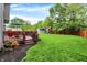 Expansive backyard with a deck, lush green lawn, playset, and shed, ideal for Gathering enjoyment at 10310 Foxwood W Dr, Carmel, IN 46280