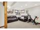Cozy basement living area with comfortable leather couches, workout bike, and wall decor, designed for relaxation and recreation at 10310 Foxwood W Dr, Carmel, IN 46280