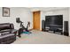 Finished basement with seating, workout area, and entertainment setup, offering space for both relaxation and activities at 10310 Foxwood W Dr, Carmel, IN 46280