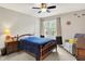 Comfortable bedroom featuring neutral walls, a ceiling fan, natural lighting, and wooden accents, creating a cozy atmosphere at 10310 Foxwood W Dr, Carmel, IN 46280