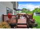Cozy deck featuring a table, grill, and colorful flowers, perfect for outdoor dining and relaxation at 10310 Foxwood W Dr, Carmel, IN 46280