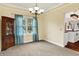 Bright dining room with chandelier, a large window, and access to the kitchen, offering a welcoming space at 10310 Foxwood W Dr, Carmel, IN 46280