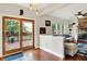 Open-concept living room with hardwood floors, sliding doors to the deck, and view of the connected great room at 10310 Foxwood W Dr, Carmel, IN 46280
