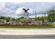 Nicely landscaped roundabout in a neighborhood with an impressive eagle sculpture centerpiece at 10310 Foxwood W Dr, Carmel, IN 46280