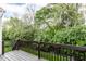 Wooden back deck area overlooking green lawn and lush greenery at 1041 Lincoln Park E Dr, Greenwood, IN 46142