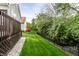 Backyard featuring a well-maintained lawn, fence line, and home's exterior at 1041 Lincoln Park E Dr, Greenwood, IN 46142