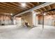 Unfinished basement featuring exposed beams, concrete foundation, and stairs at 1041 Lincoln Park E Dr, Greenwood, IN 46142