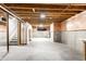Unfinished basement with exposed beams, concrete walls, and stairs at 1041 Lincoln Park E Dr, Greenwood, IN 46142