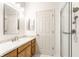 Bathroom with granite vanity top, decorative mirror, and glass door shower at 1041 Lincoln Park E Dr, Greenwood, IN 46142
