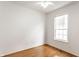 Minimalist bedroom with hardwood floors, white walls, a window, and a ceiling fan at 1041 Lincoln Park E Dr, Greenwood, IN 46142