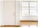Bright foyer featuring hardwood floors, a white door, and a window providing natural light at 1041 Lincoln Park E Dr, Greenwood, IN 46142