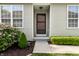 A welcoming front entrance with a screen door, sidelight windows, and manicured landscaping at 1041 Lincoln Park E Dr, Greenwood, IN 46142