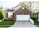 Charming single-Gathering home with a brick facade, attached two-car garage and well-manicured lawn at 1041 Lincoln Park E Dr, Greenwood, IN 46142
