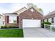 Charming single-Gathering home with a brick facade, attached two-car garage and well-manicured lawn at 1041 Lincoln Park E Dr, Greenwood, IN 46142