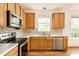 Close up of the modern kitchen showcasing stainless steel appliances and stylish tile backsplash at 1041 Lincoln Park E Dr, Greenwood, IN 46142
