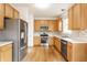 Well-lit kitchen features stainless steel appliances, oak cabinets, and a stylish backsplash at 1041 Lincoln Park E Dr, Greenwood, IN 46142
