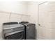 Functional laundry room with washer, dryer, overhead shelving, and door at 1041 Lincoln Park E Dr, Greenwood, IN 46142