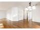 Spacious living room with hardwood floors, neutral walls, and a modern light fixture at 1041 Lincoln Park E Dr, Greenwood, IN 46142