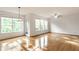 Bright living room with hardwood floors, many windows, and a ceiling fan for comfortable living at 1041 Lincoln Park E Dr, Greenwood, IN 46142