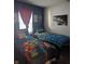 Shared bedroom featuring two twin beds with vibrant bedding and playful decorations, perfect for children at 10425 Candy Apple Ln, Indianapolis, IN 46235