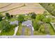 Expansive aerial view of a charming home with a pool and well-manicured lawn and mature trees surrounded by farmland at 10456 N State Rd 267, Brownsburg, IN 46112