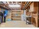 Unfinished basement features open rafters, concrete floors, work table and shelving at 10456 N State Rd 267, Brownsburg, IN 46112