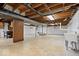 Spacious unfinished basement with concrete floor, pegboard and white block walls at 10456 N State Rd 267, Brownsburg, IN 46112